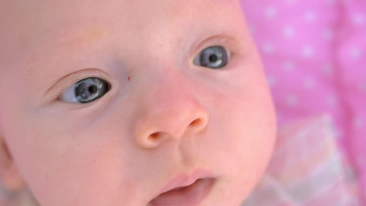 Download Video Stock Closeup Of A Young Baby Looking Around Live Wallpaper For PC
