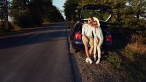 Video Stock Cinematic View Of Couple Sitting On Car In Countryside Live Wallpaper For PC