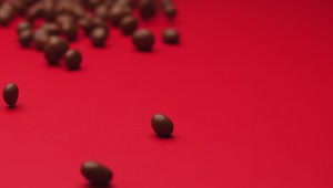 Video Stock Chocolate Beans Rolling On A Red Surface Live Wallpaper For PC