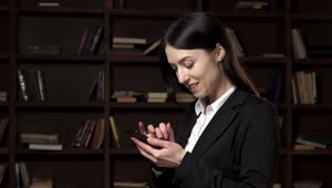 Video Stock Businesswoman Texting In The Library Live Wallpaper For PC