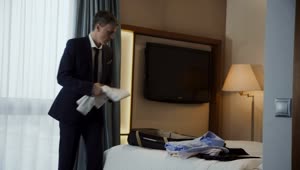 Video Stock Businessman Preparing The Luggage In A Hotel Room Live Wallpaper For PC