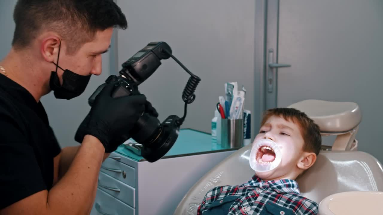 Download Stock Video Dentist Taking Photos Of A Little Boys Teeth Live Wallpaper For PC