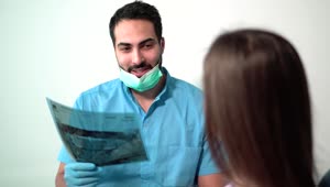 Stock Video Dentist Explaining A Tooth X Ray To A Patient Live Wallpaper For PC