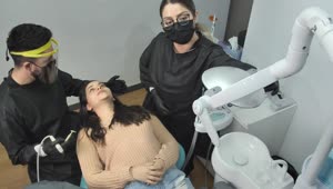 Stock Video Dentist And His Assistant Working With A Patient Live Wallpaper For PC