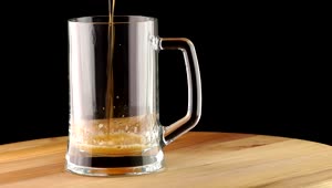 Stock Video Dark Beer Poured Into A Transparent Mug Live Wallpaper For PC