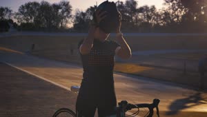Stock Video Cyclist Putting On Her Helmet Before Training Live Wallpaper For PC