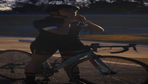 Stock Video Cyclist Girl Putting On Her Helmet Before Training Live Wallpaper For PC