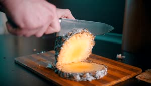Stock Video Cutting A Pineapple In Pieces With A Knife Live Wallpaper For PC