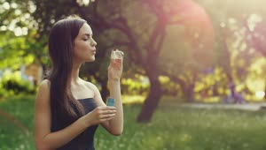 Stock Video Cute Young Woman Blowing Bubbles In The Park Live Wallpaper For PC