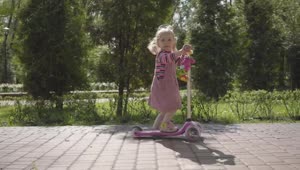 Stock Video Cute Little Girl Rides Scooter Down Brick Sidewalk Live Wallpaper For PC