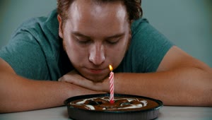 Stock Video Crestfallen Man Blowing Out The Candle On A Cake Live Wallpaper For PC