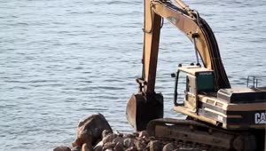 Stock Video Crane Digging On Rocks At The Sea Live Wallpaper For PC