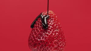 Stock Video Cover A Strawberry With Chocolate Syrup On A Red Background Live Wallpaper For PC