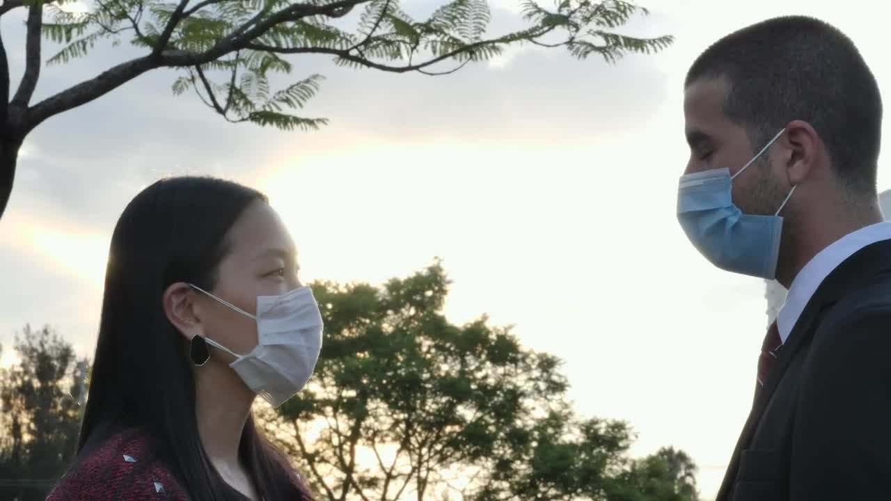 Download Stock Video Couple Wearing Face Masks Under A Beautiful Sunset Live Wallpaper For PC