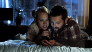 Stock Video Couple Watching The Smartphone In The Bed Live Wallpaper For PC