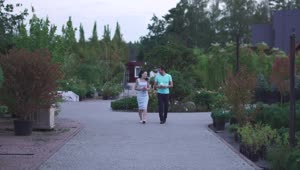 Stock Video Couple Walks In A Garden While Chatting Live Wallpaper For PC