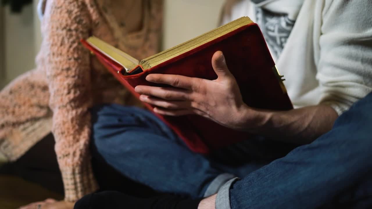 Download Stock Video Couple Sitting Watching A Photo Album Live Wallpaper For PC