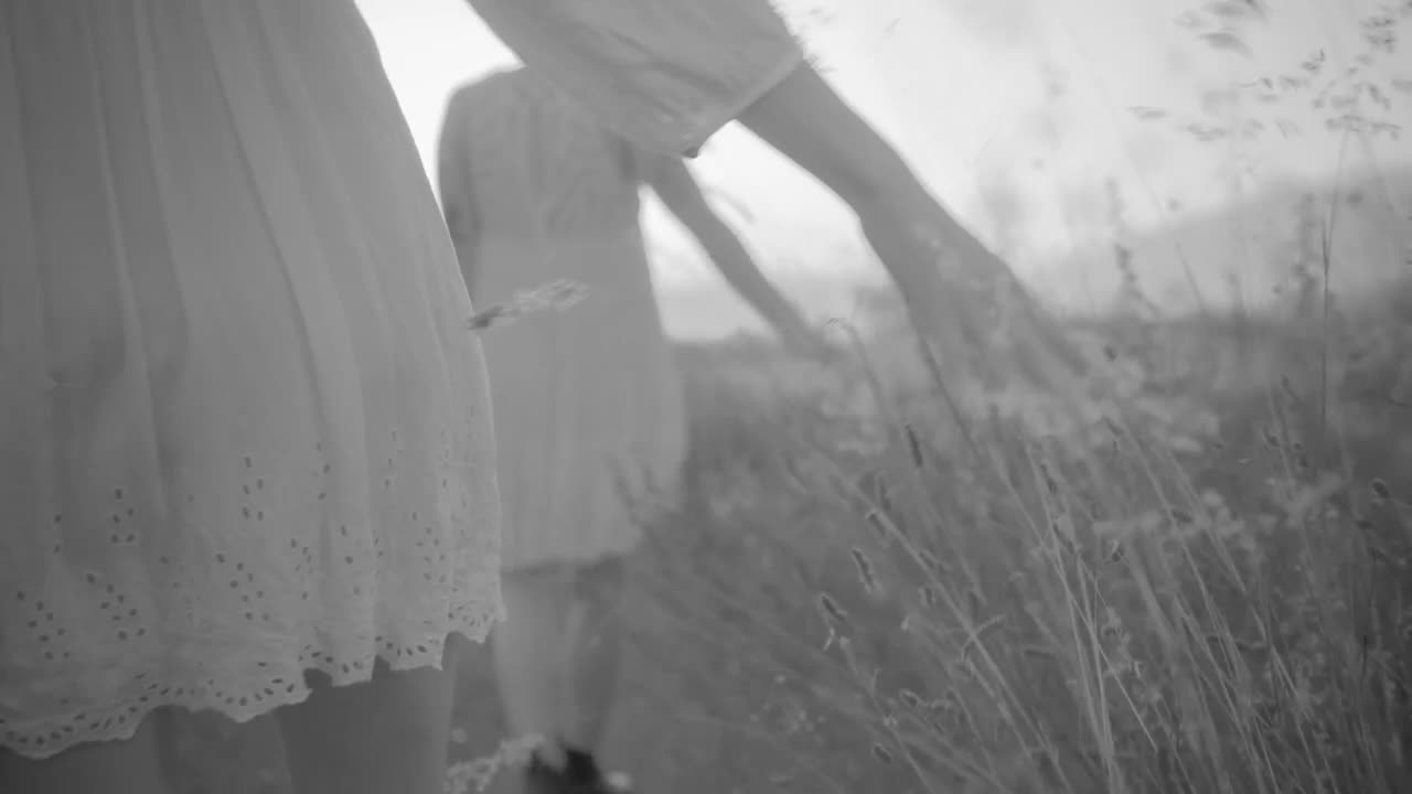 Download Stock Video Couple Of Women Dressed In White Walking Across The Field Live Wallpaper For PC