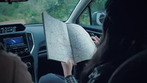 Stock Video Couple Of Adventurers Reading A Map Inside A Car Live Wallpaper For PC