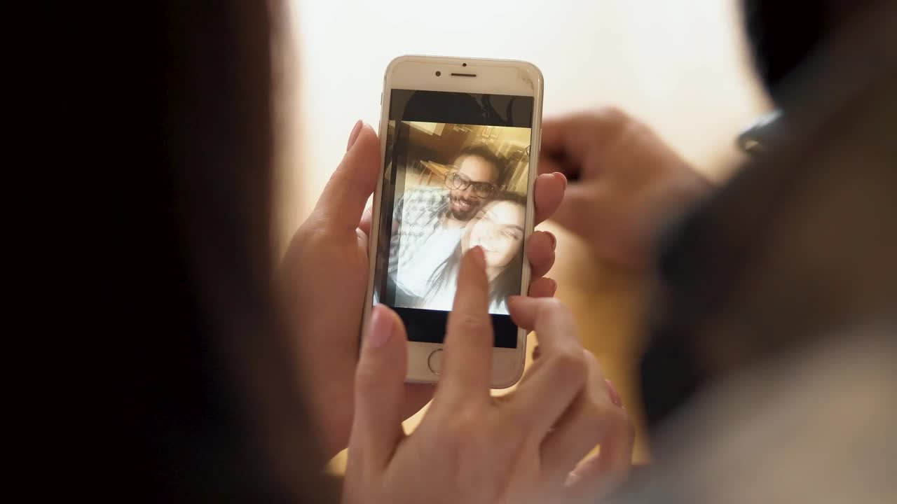 Download Stock Video Couple Looking At Selfies In Their Cell Phone Live Wallpaper For PC