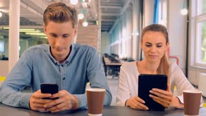 Stock Video Couple In A Cafe Connected On Their Mobile Devices Live Wallpaper For PC