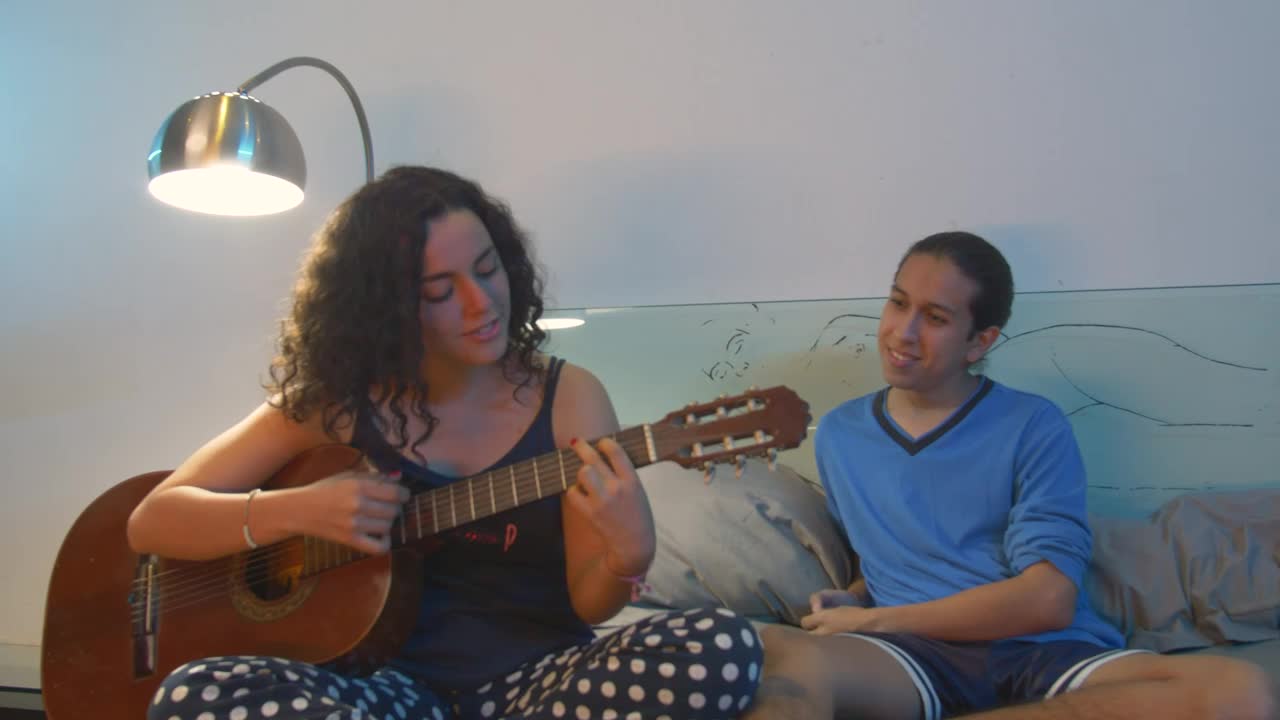 Download Stock Video Couple Hanging Out While She Plays Guitar Live Wallpaper For PC