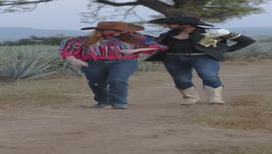 Stock Video Couple Dressed As Charros Walking Through A Farm Live Wallpaper For PC