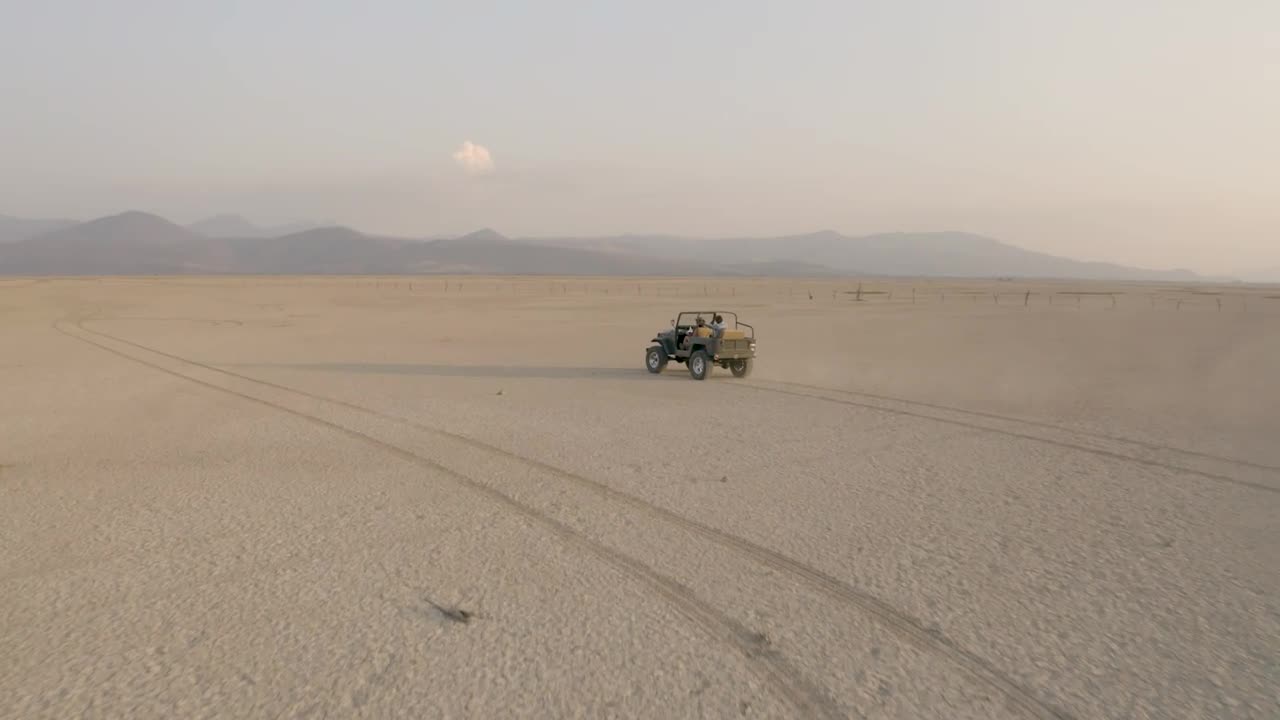 Download Stock Video Convertible Jeep Crossing A Large Desert In Aerial Shot Live Wallpaper For PC