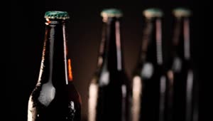 Stock Video Cold Beer Bottles In A Row On A Dark Background Live Wallpaper For PC