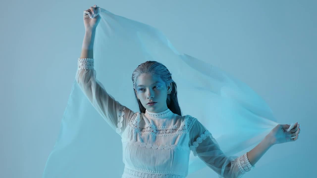 Download Stock Video Cold And Pale Looking Woman On A Blue Background Live Wallpaper For PC