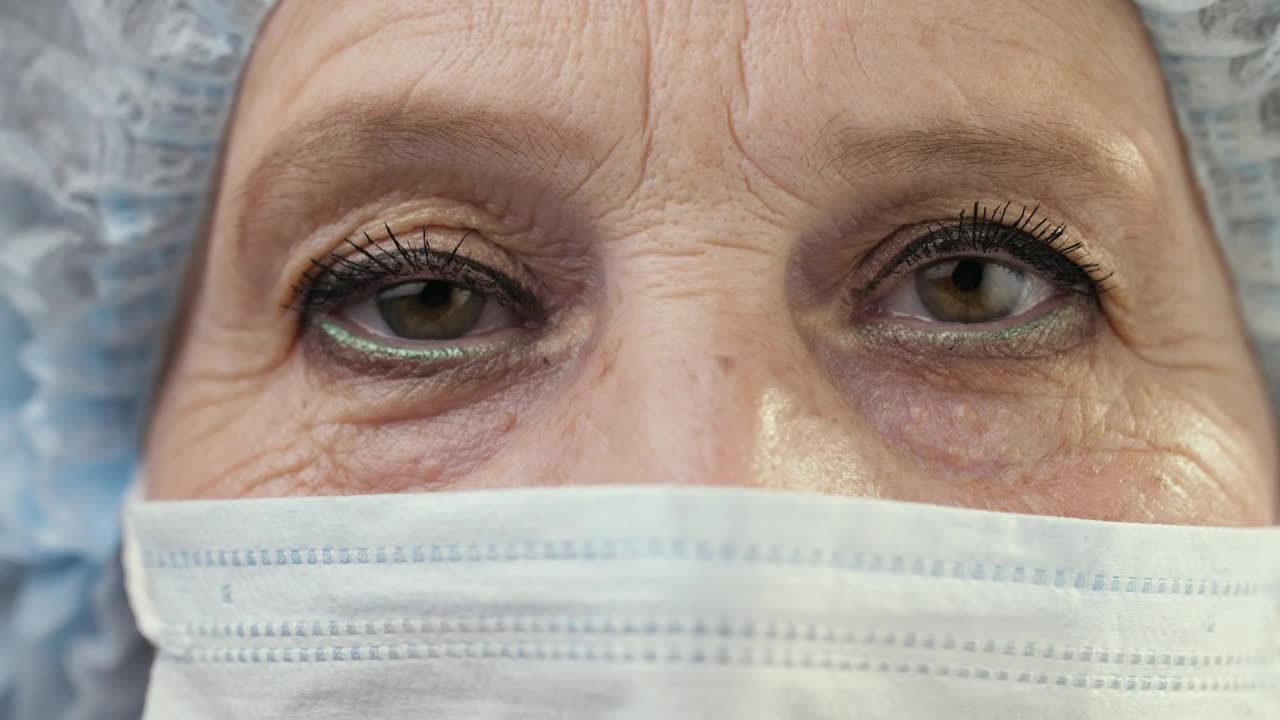 Download Stock Video Eyes Of An Old Female Doctor Wearing Mask Live Wallpaper For PC