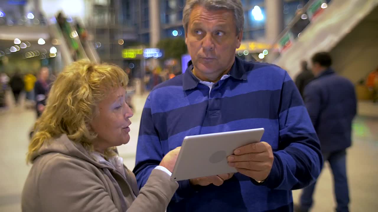 Download Stock Video Elderly Couple Using A Tablet While Out In Town Live Wallpaper For PC