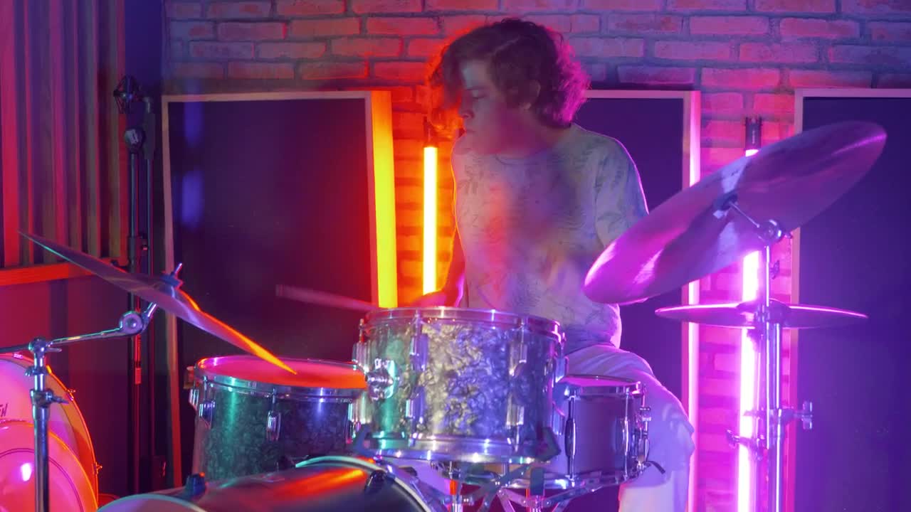 Download Stock Video Drummer Playing In A Studio With Neon Lights Live Wallpaper For PC