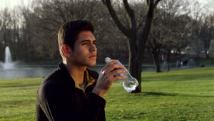 Stock Video Drinking From A Water Bottle In The Park Live Wallpaper For PC