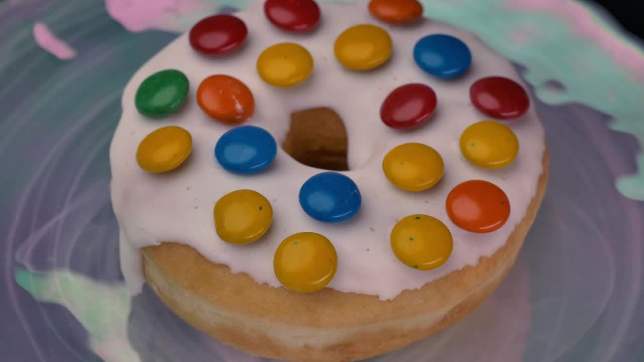 Download Stock Video Donut With White Frosting And Colored Chocolates Live Wallpaper For PC