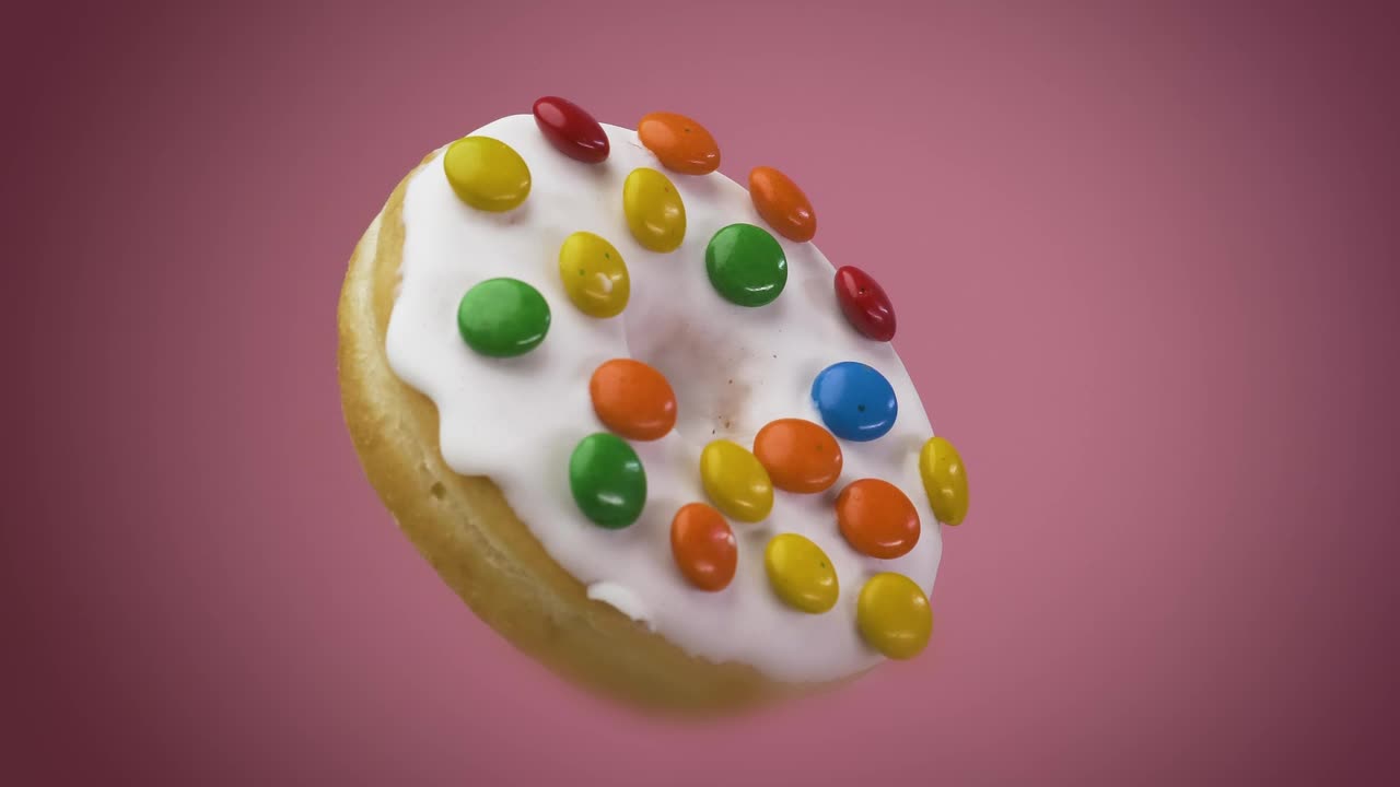 Download Stock Video Donut With Icing Chocolates Rotating On A Pink Background Live Wallpaper For PC