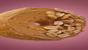 Stock Video Donut With Peanut Butter And Peanuts On A Pink Background Live Wallpaper For PC