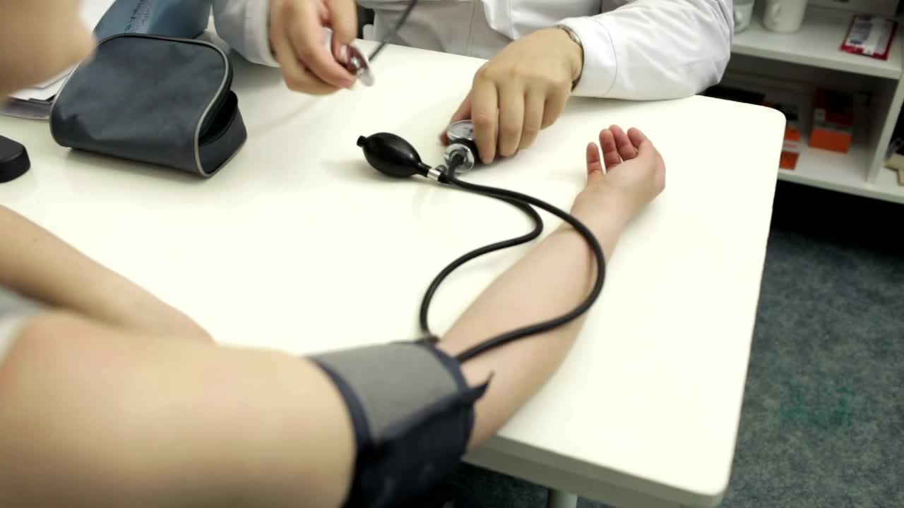 Download Stock Video Doctor Measuring The Blood Pressure Of A Patient Live Wallpaper For PC