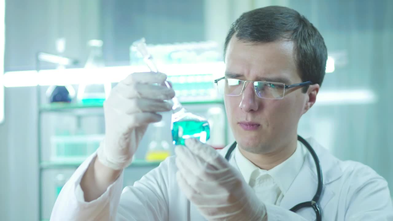 Download Stock Video Doctor Looking To A Flask With Blue Liquid Live Wallpaper For PC