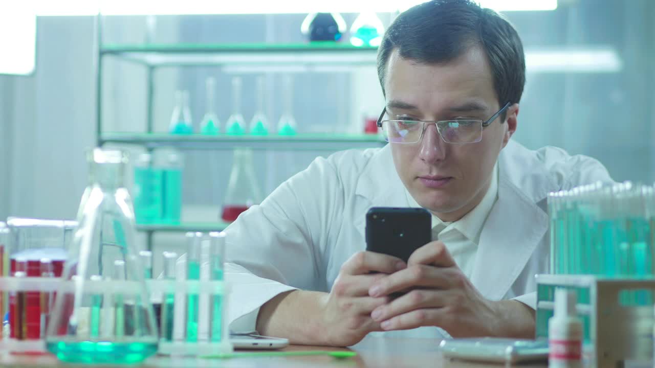 Download Stock Video Doctor In The Lab Looking At His Phone Live Wallpaper For PC