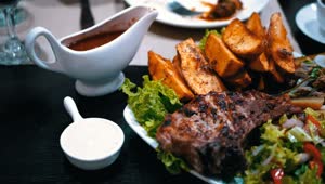 Download Stock Video Dish Of Meat Potatoes And Salad In A Restaurant Live Wallpaper For PC