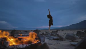 Download Stock Video Deserted Plain With A Campfire And A Woman Practicing Yoga Live Wallpaper For PC