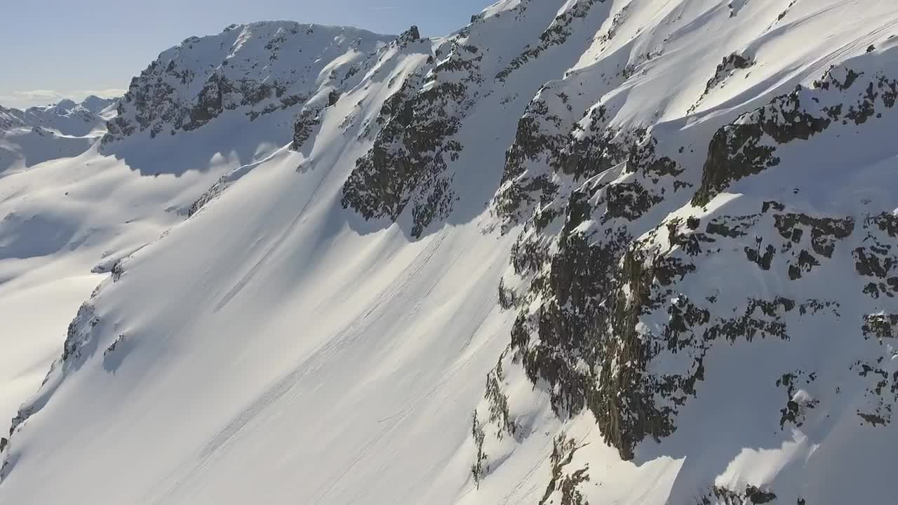 Download Stock Video Flying Through A Snowy Mountain With Rocks Live Wallpaper For PC