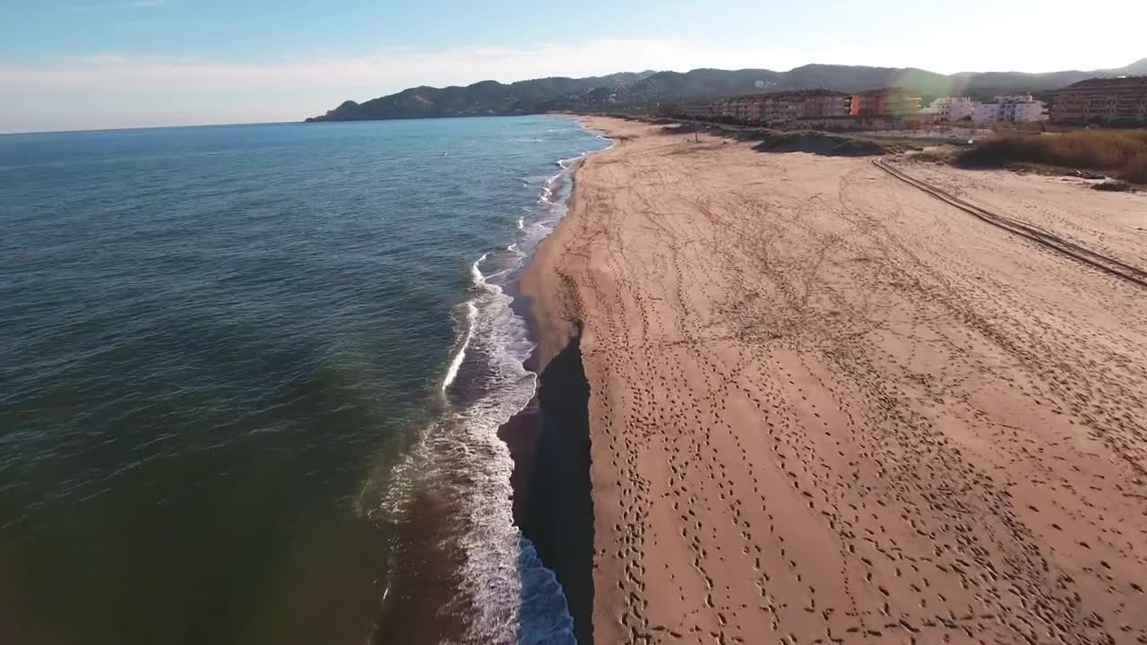 Download Stock Video Flying Over The Shore Of A Long Beach Live Wallpaper For PC