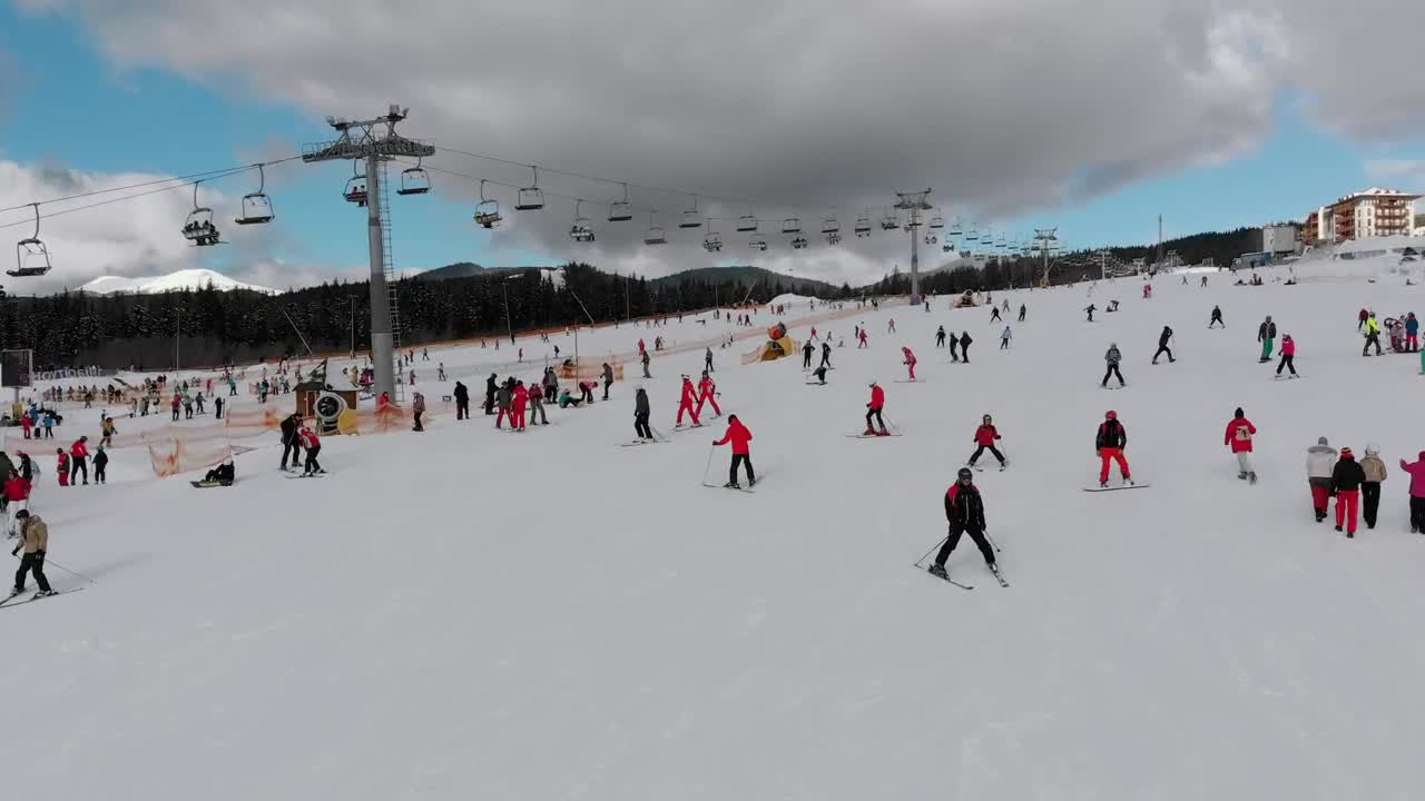 Download Stock Video Flying Over Skiers In The Snowy Mountain Live Wallpaper For PC
