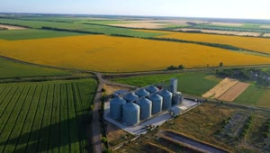 Stock Video Flying Over Grain Silos And Sunflower Fields Live Wallpaper For PC