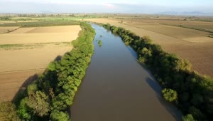 Stock Video Flying Over A River Between Agricultural Fields Live Wallpaper For PC
