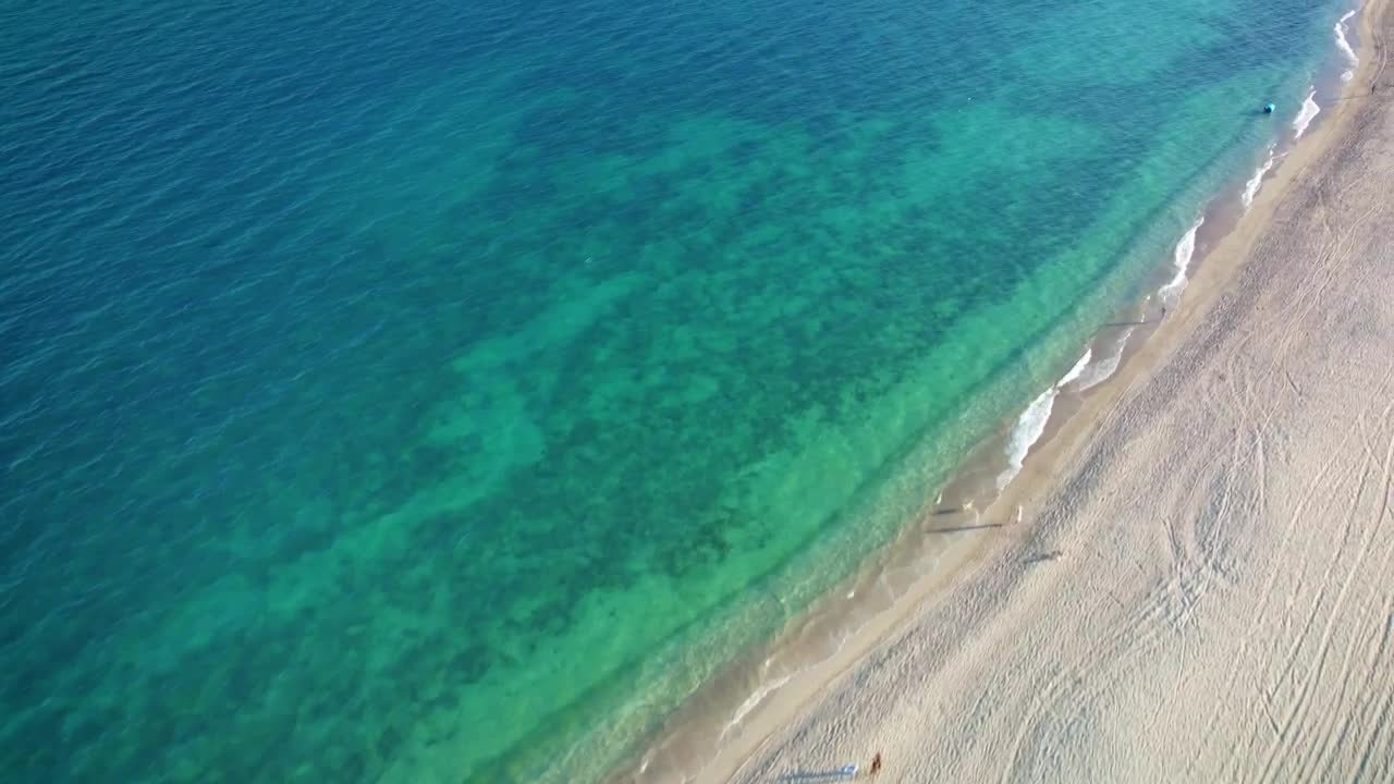 Download Stock Video Flying Over A Peaceful And Sunny Beach Live Wallpaper For PC