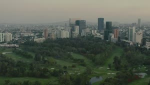 Stock Video Flying Over A Large Park Surrounded By A Metropolis Live Wallpaper For PC