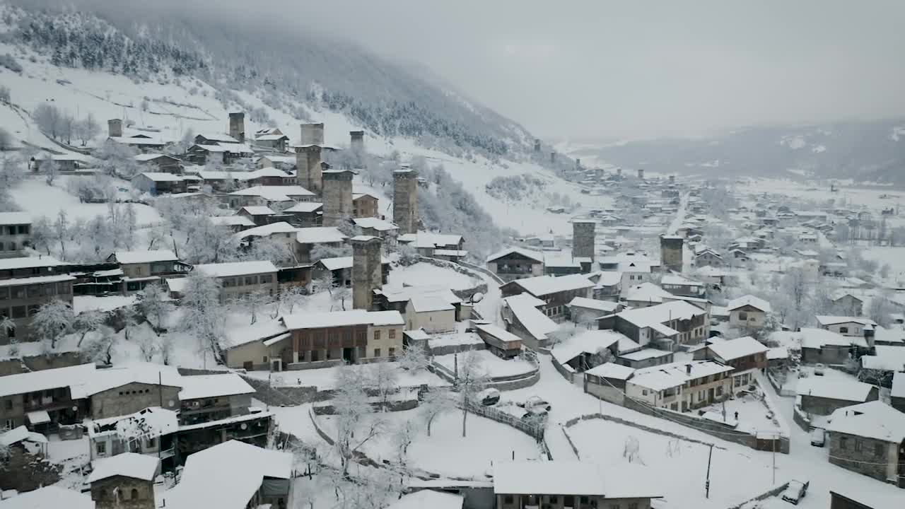Download Stock Video Flying Above A Town With Old Towers Covered In Snow Live Wallpaper For PC